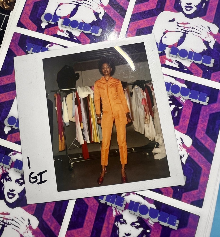 Polaroid Photo of hot model in orange channel jumpsuit London 1983 fashion is