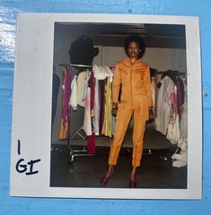 Polaroid Photo of hot model in orange channel jumpsuit London 1983 fashion is
