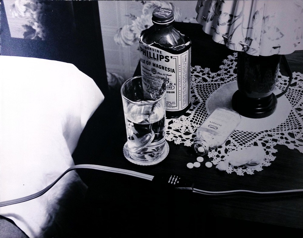 Vintage bedside table with medicine and drink bottle