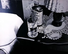 Vintage bedside table with medicine and drink bottle