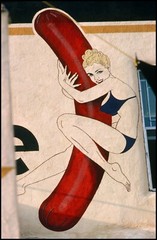 HOLLWOOD WALL GRAPHIC OF A GIRL HUGGING A HOT DOG. JULY 1977