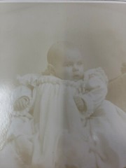 Antique Cabinet Card Photograph- Baby in a white dress sitting for a photograph
