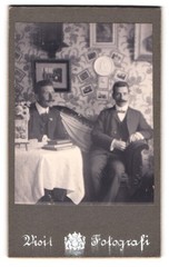 Photograph Two Gentlemen Sitting On A Couch