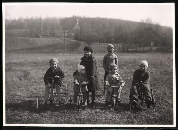 Photograph Children with Tricycle & Pedal Car Playing in a Meadow