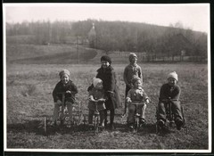 Photograph Children with Tricycle & Pedal Car Playing in a Meadow