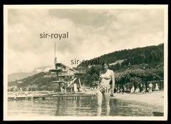 Pretty woman in bikini in front of diving tower in outdoor pool – 1960s – photo 10x7cm