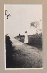 Vintage Photograph of a Woman Standing on a Road, in a Grey Matte Frame