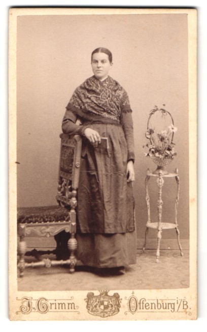 Photograph J. Grimm, Offenburg, woman with scarf next to chair and flower stand