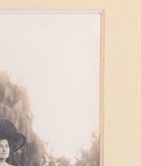 Vintage Photograph of a Woman Wearing a White Dress and a Black Hat