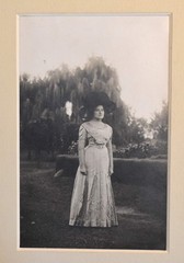Vintage Photograph of a Woman Wearing a White Dress and a Black Hat