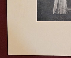 Vintage Photograph of a Woman Wearing a White Dress and a Black Hat