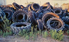 VINTAGE TIRE SALVAGE SCRAP YARD SALVAGE LANDSCAPE SURREAL COLOR PHOTOGRAPH