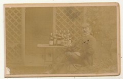Photo on cardboard – gentleman with many bottles – around 1900