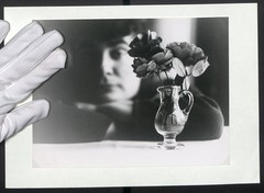 Photograph Stylistically Captured Vase With Roses In Front Of One Person