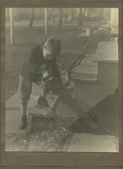 Young boy with hand saw cutting wood antique art photo by Leo Kraft