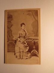 sitting young woman in crinoline with album – backdrop / CDV A. Obersteiner Graz