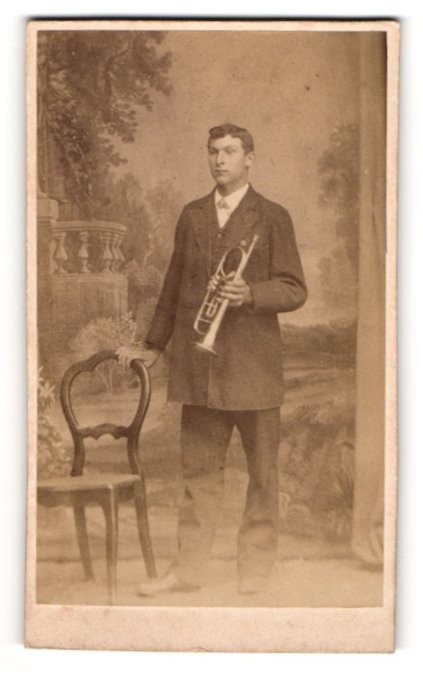 Photograph Young Man as Musician with Trumpet in Front of a Studio Backdrop