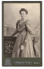 Photograph Hermann Tietz, Berlin, Alexanderplatz, young lady with flower wearing mod