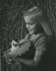 Laughing girl with meowing kitten in straw hat fun vintage cat photo
