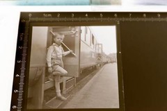 Great old negative – boy gets out of passenger car railway place?