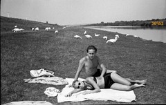 young couple in swimsuits, geese on riverside, unusual vintage fine art negative