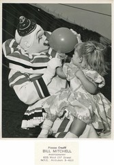 Clown with girl blowing up balloon vintage circus photo
