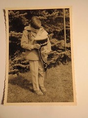 Boy standing in the garden with school bag – enrollment school student / photo