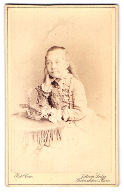 Photograph Rob. Cox, Weston-super-Mare, Portrait of a Child with Basket of Flowers