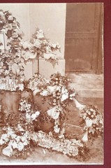 Antique Photograph Depicting a Woman’s Memorial with a Floral Arrangement