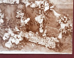 Antique Photograph Depicting a Woman’s Memorial with a Floral Arrangement