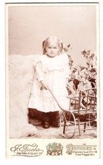 CDV photo around 1900, pretty little girl with doll’s car, Dresden