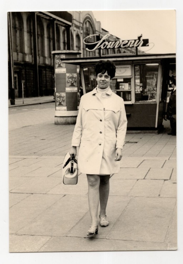Photo lady in trench coat GDR 1970s probably Dresden souvenir kiosk