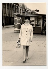 Photo lady in trench coat GDR 1970s probably Dresden souvenir kiosk