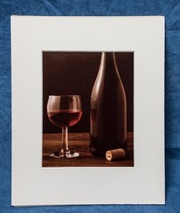 Wine Glass & Bottle with cork wood table black background photograph