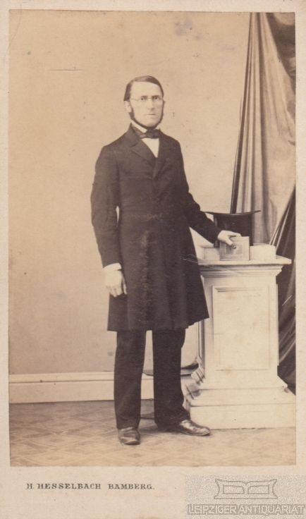 Portrait middle-class gentleman with glasses, top hat and whiskers, photograph. 1866