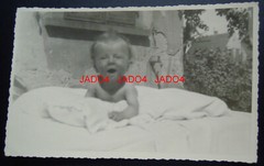 REAL PHOTO POSTCARD / CHILDREN’S PHOTO – SMALL CHILD (BABY) IN THE GARDEN