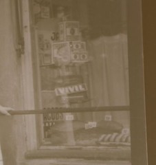 old negative – woman standing in front of shop food – civil advertising
