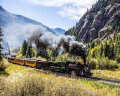 8×10 Color photo of vintage train traveling between 2 mountains.