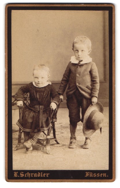 Photograph E. Schradler, feet, portrait two children in dress and suit with St