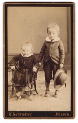 Photograph E. Schradler, feet, portrait two children in dress and suit with St
