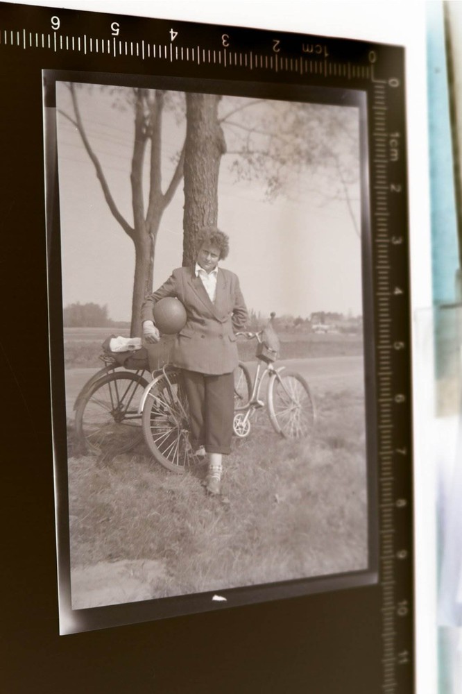 Great old negative woman with football and two bikes 1950-60s?