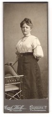Photograph Carl Wolf, Harburg, at the war memorial, young woman with updo