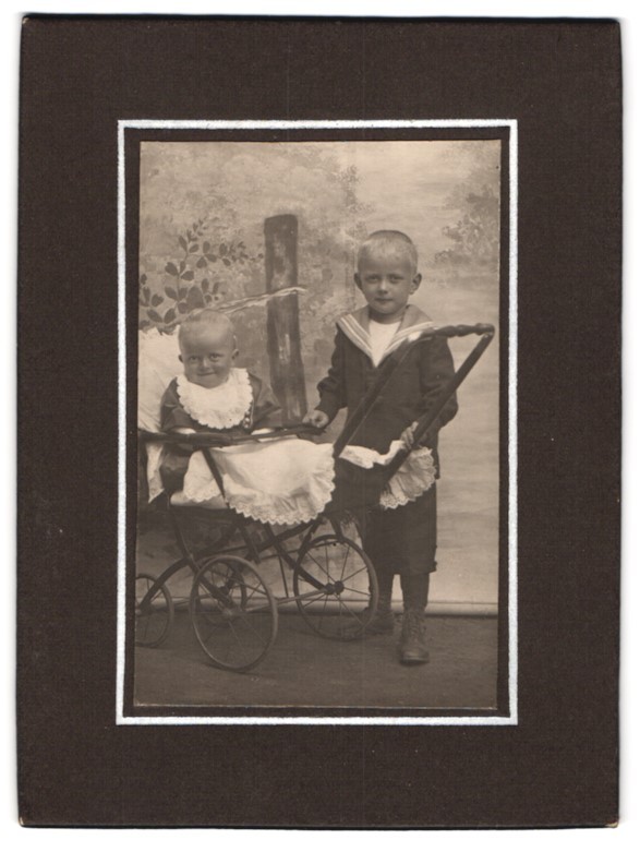 Photograph baby in pram with boy in sailor suit