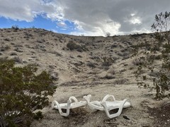 Two Pool Chairs Lie In California Desert