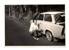 Photo of early man Trabant changing wheels country road Trabbi vintage 1973