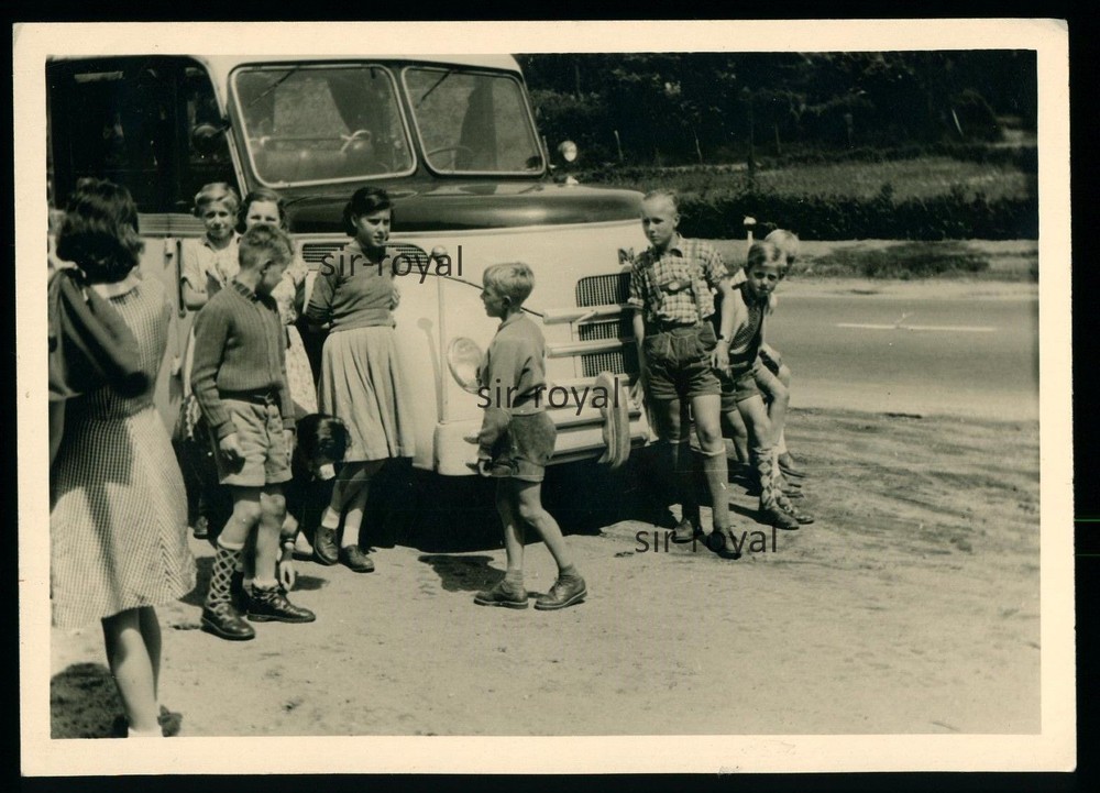 Boys in leather trousers in front of MAN bus – photo 13x9cm