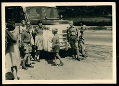 Boys in leather trousers in front of MAN bus – photo 13x9cm