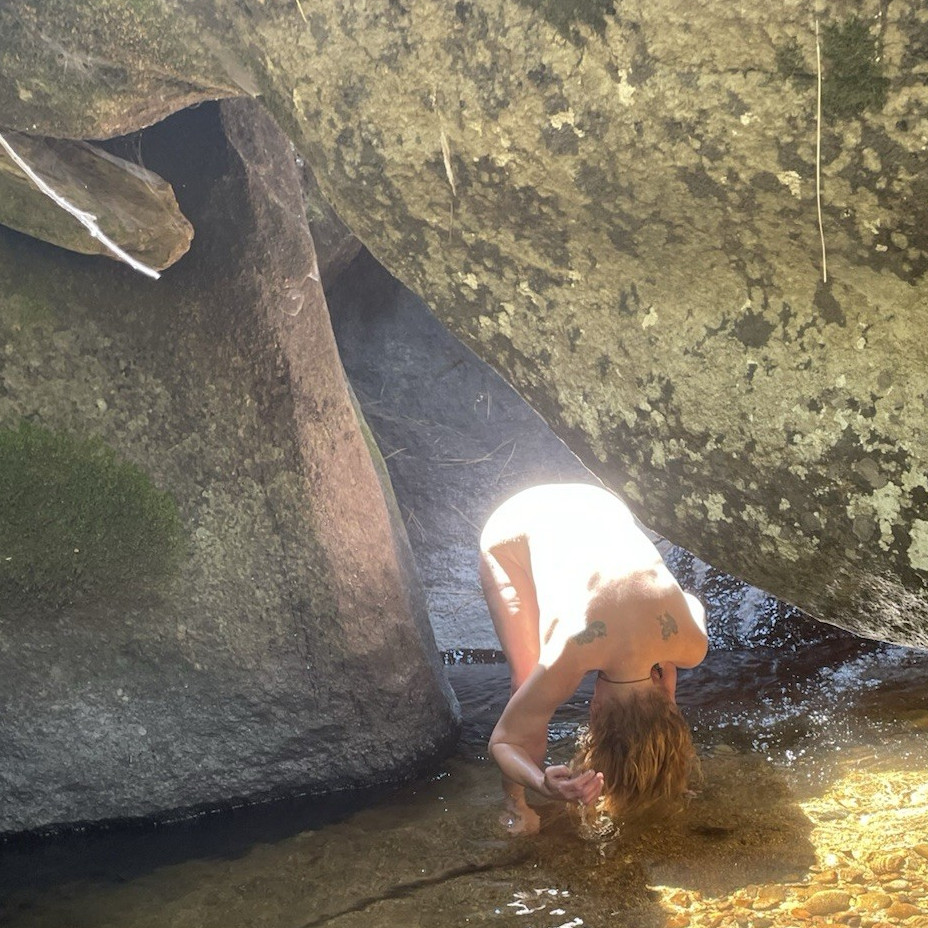 Person Washing Hair in Rocky Creek Outdoor Activity Photo (Listing Image)