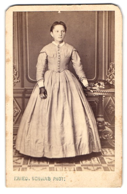 Photograph F. Ried, young girl in bright wide dress with fingerless hands