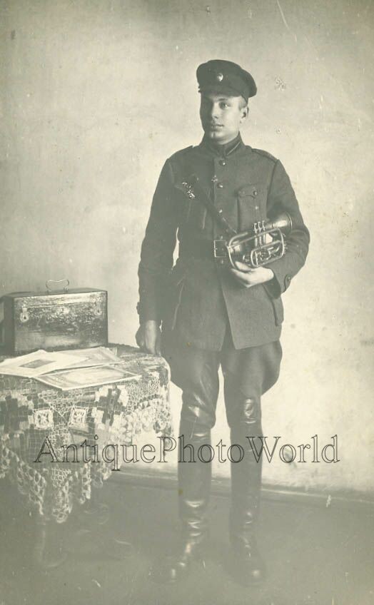 Young soldier with trumpet antique music photo